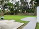 Large backyard with grassy area, patio, and deck at 2549 Arapaho St, Sarasota, FL 34231