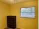 Simple bedroom with a dresser and window coverings at 2549 Arapaho St, Sarasota, FL 34231