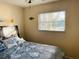 Cozy bedroom with hardwood floors and a large window at 2549 Arapaho St, Sarasota, FL 34231