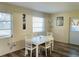 Bright dining area with white table and chairs, vinyl flooring at 2549 Arapaho St, Sarasota, FL 34231