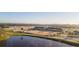 Aerial view of a large equestrian center with arenas, stables, and a pond at 32108 Grand National Dr, Myakka City, FL 34251