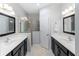 Spacious bathroom with double sinks, a shower, and dark brown vanity at 5450 Fairfield Blvd, Bradenton, FL 34203