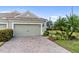 Two-car garage with paver driveway and landscaping at 5450 Fairfield Blvd, Bradenton, FL 34203