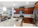 Kitchen with wood cabinets, granite countertops, and stainless steel appliances at 5450 Fairfield Blvd, Bradenton, FL 34203