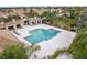 Community pool with surrounding lounge chairs and shaded areas at 5450 Fairfield Blvd, Bradenton, FL 34203