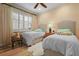 Cozy bedroom with two twin beds, soft bedding, and plenty of natural light at 8480 Big Buck Ln, Sarasota, FL 34240