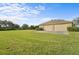 Tan colored three-car garage with double doors and a concrete pad at 8480 Big Buck Ln, Sarasota, FL 34240