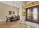 Elegant dining room with a dark wood table and six chairs, complemented by modern light fixtures at 8480 Big Buck Ln, Sarasota, FL 34240