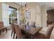 Formal dining room with large table and chandelier at 8480 Big Buck Ln, Sarasota, FL 34240