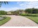 Beautiful home with a curving brick driveway and manicured landscaping at 8480 Big Buck Ln, Sarasota, FL 34240