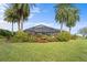 Expansive enclosed patio area with tropical landscaping and a view of the yard at 8480 Big Buck Ln, Sarasota, FL 34240