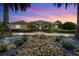 Elegant home with a stone pathway and landscape lighting at 8480 Big Buck Ln, Sarasota, FL 34240