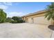 Three-car garage with large concrete driveway at 8480 Big Buck Ln, Sarasota, FL 34240