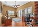 Home office featuring built-in shelving and hardwood floors at 8480 Big Buck Ln, Sarasota, FL 34240