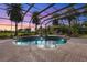 Inviting screened-in pool and spa with brick pavers at 8480 Big Buck Ln, Sarasota, FL 34240