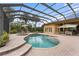 Relaxing pool area with a covered patio and solar panels at 8480 Big Buck Ln, Sarasota, FL 34240