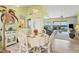 Bright dining area with white wicker chairs and a view into the living room at 946 Sandpiper Cir # 946, Bradenton, FL 34209