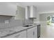 Modern kitchen with granite countertops and gray tile backsplash at 5310 26Th W St # 2703, Bradenton, FL 34207