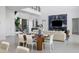 Open concept dining room with modern wooden table and white chairs at 1212 Center Pl, Sarasota, FL 34236