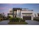 Modern two-story home with a gray and white exterior, and a three-car garage at 1212 Center Pl, Sarasota, FL 34236