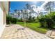 Peaceful backyard patio with firepit and grassy area at 2629 Rolling Rd, North Port, FL 34288