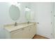 Double vanity bathroom with marble countertop and large mirrors at 2629 Rolling Rd, North Port, FL 34288