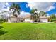 Single-story home with white exterior and palm trees at 2629 Rolling Rd, North Port, FL 34288