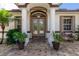 Elegant front entrance with double doors and columns at 2629 Rolling Rd, North Port, FL 34288