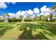 Large grassy lot with tropical landscaping and palm trees at 2629 Rolling Rd, North Port, FL 34288