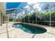 Relaxing kidney-shaped pool with screened enclosure at 2629 Rolling Rd, North Port, FL 34288