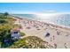 Expansive beach with lifeguard stand and many people enjoying the sun at 333 Bocelli Dr, Nokomis, FL 34275