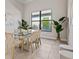 Elegant dining room featuring a glass-top table and woven chairs at 333 Bocelli Dr, Nokomis, FL 34275