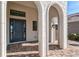 Elegant entryway with arched details and a dark gray door at 333 Bocelli Dr, Nokomis, FL 34275