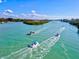 Peaceful waterway with boats passing through mangroves at 333 Bocelli Dr, Nokomis, FL 34275