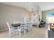 Bright dining room featuring a rustic wood table and white chairs at 4135 Dover E Dr, Bradenton, FL 34203