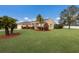 Exterior view of a single-story house with lush landscaping at 4135 Dover E Dr, Bradenton, FL 34203