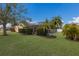 Inviting backyard oasis with a screened-in pool and lush landscaping at 4135 Dover E Dr, Bradenton, FL 34203