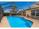 Refreshing screened-in pool with patio furniture and lounge chairs at 4135 Dover E Dr, Bradenton, FL 34203