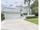 Charming gray two-story home featuring an attached two-car garage and well-manicured landscaping at 5132 36Th W St, Bradenton, FL 34210