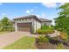 Front view of a single-story house, with a walkway and landscaping at 3121 Tolmino Ct, Bradenton, FL 34211