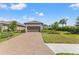 Single-story home with a paved driveway and landscaped front yard at 3121 Tolmino Ct, Bradenton, FL 34211