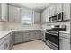 Modern kitchen with gray cabinets, white countertops, and stainless steel appliances at 3121 Tolmino Ct, Bradenton, FL 34211