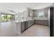 Modern kitchen with gray cabinets, white countertops, and stainless steel appliances at 3121 Tolmino Ct, Bradenton, FL 34211