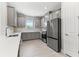 Modern kitchen featuring gray cabinets, white countertops, and stainless steel appliances at 3121 Tolmino Ct, Bradenton, FL 34211