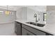 Modern kitchen island with white countertop and double sink at 3121 Tolmino Ct, Bradenton, FL 34211