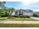 Attractive single-story home with landscaped yard and palm trees at 455 Park Trace Blvd, Osprey, FL 34229