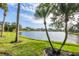 Serene lake view from a lush, grassy backyard at 455 Park Trace Blvd, Osprey, FL 34229