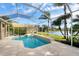 Relaxing screened-in pool and spa with lake view at 455 Park Trace Blvd, Osprey, FL 34229