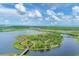 Aerial view of a scenic island with walking paths in a lake at 602 84Th Nw St, Bradenton, FL 34209