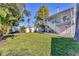 Large grassy backyard, adjacent to a two-story house with a deck and stairs at 602 84Th Nw St, Bradenton, FL 34209